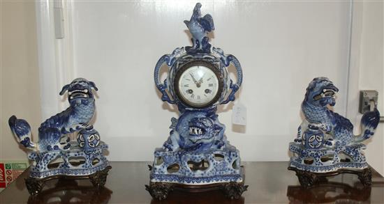 A 19th century French faience clock garniture, clock 18in.